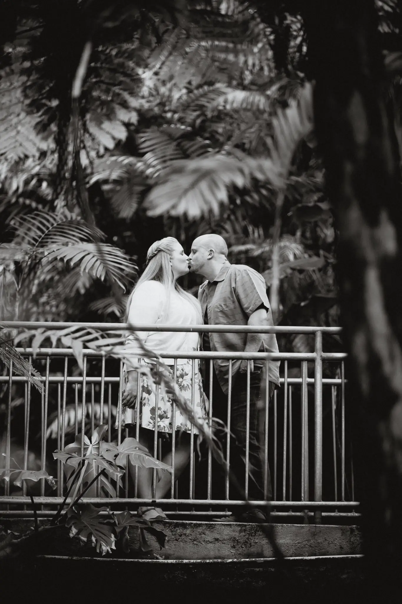 Black and white engagement photo on a bridge