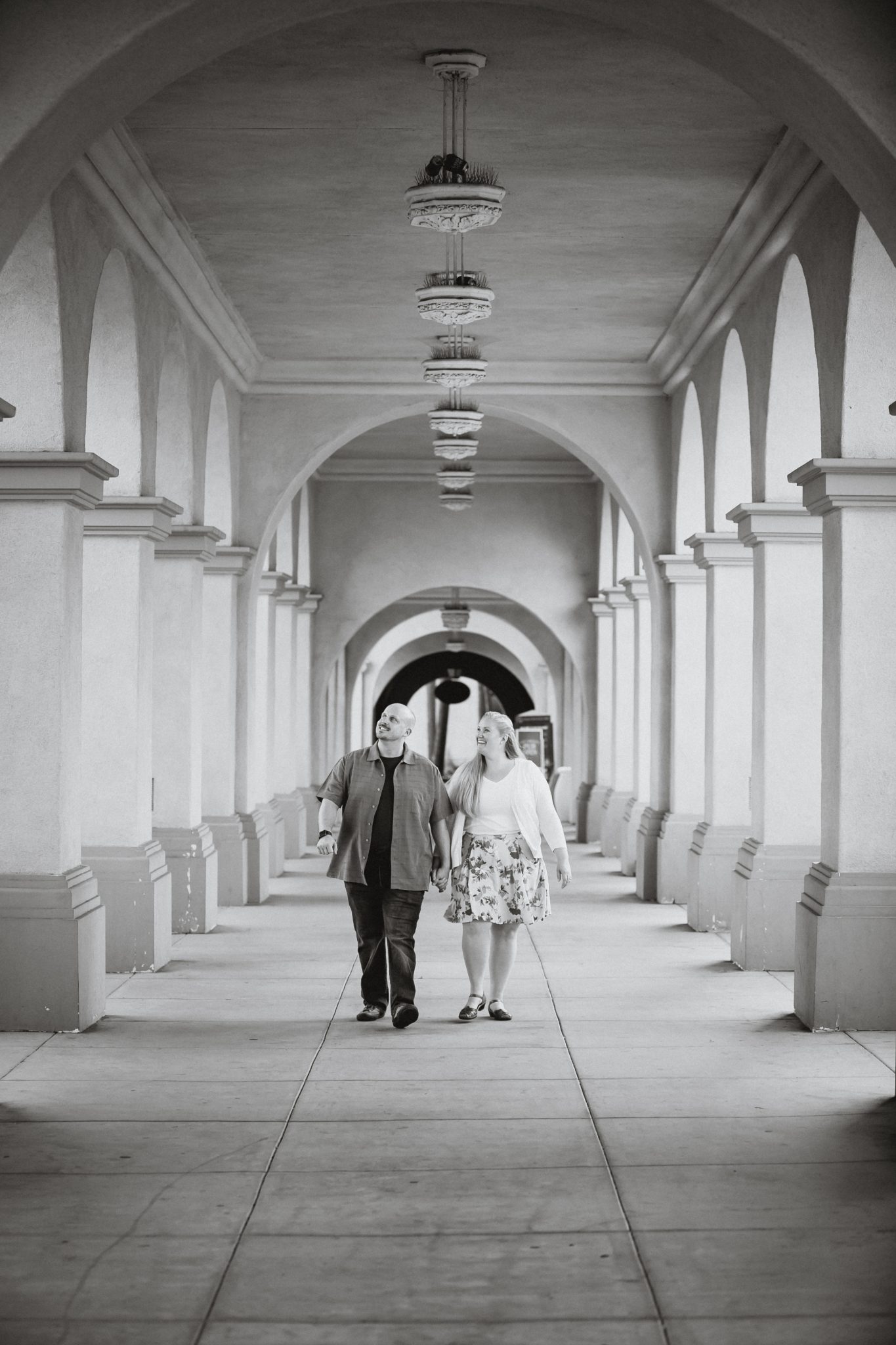 Guy and girl walking between columns