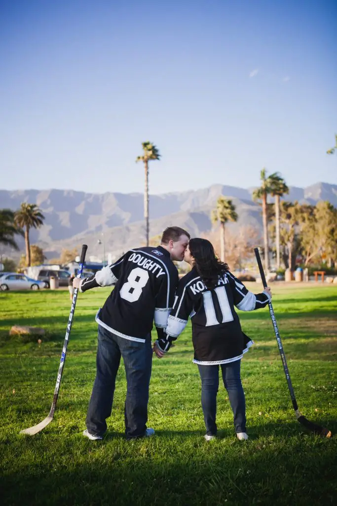 Couple wearing Kings hockey jerseys during a photo shoot