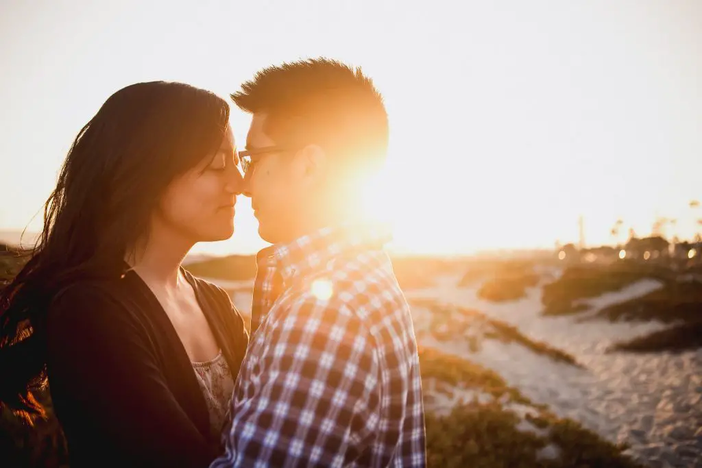 Romantic sunflare image of the couple during an engagement session