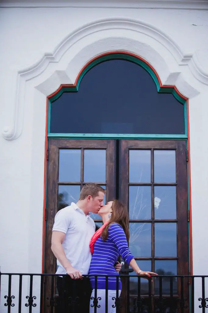 Engagement photo at Balboa Park with the couple kissing