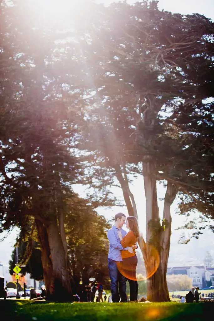 Park engagement session with a sunflare