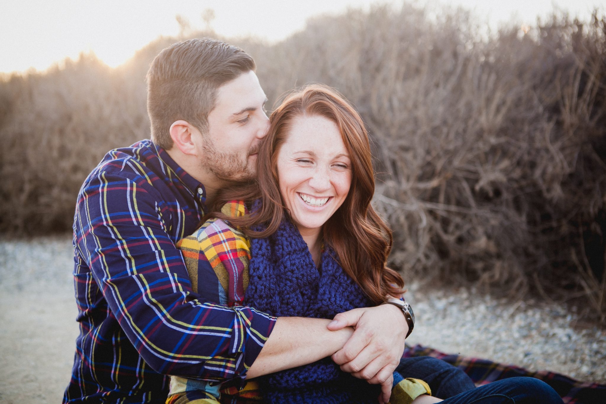Couple wearing flannel shirts for fall engagement outfits