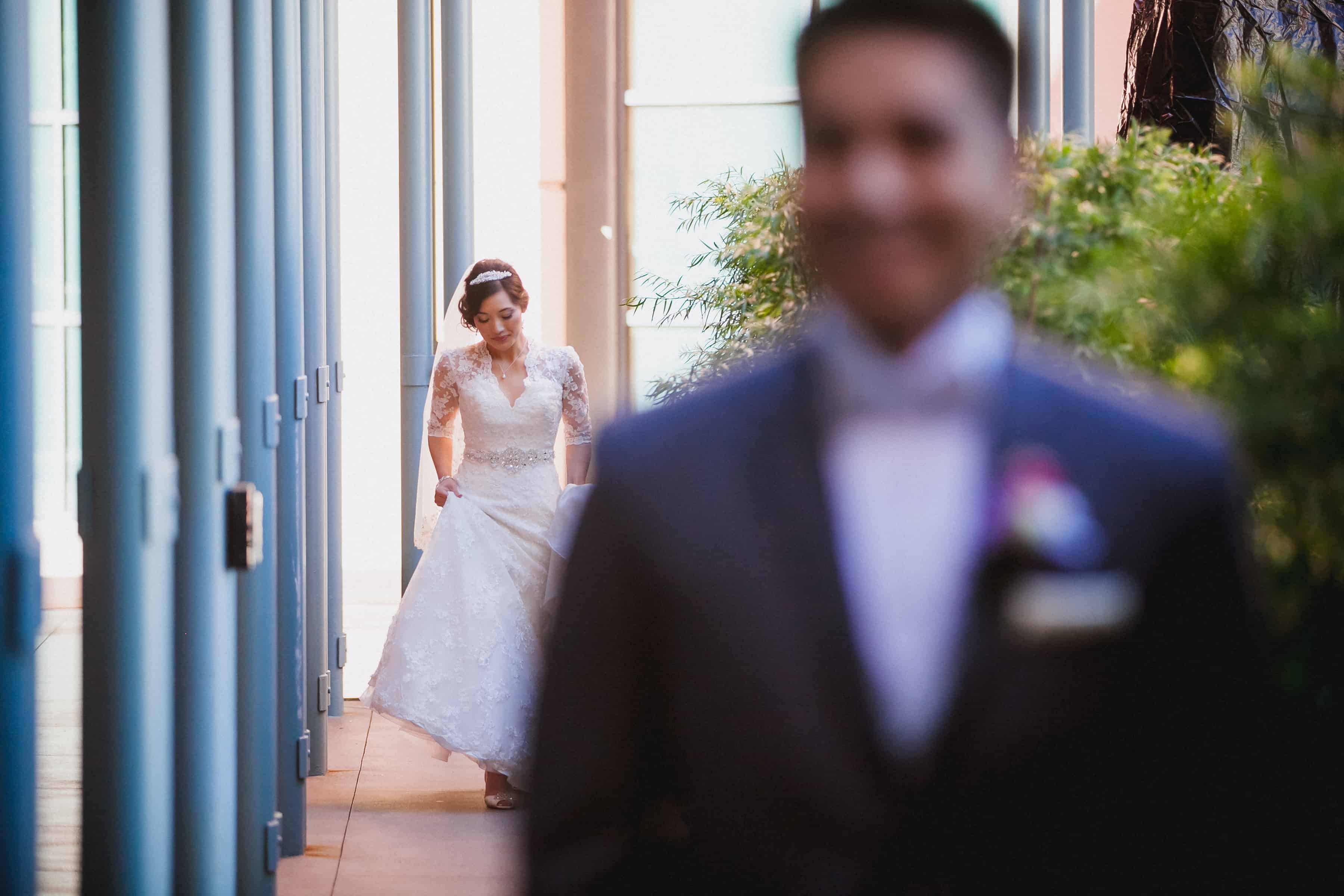 bride walking towards groom during the first look