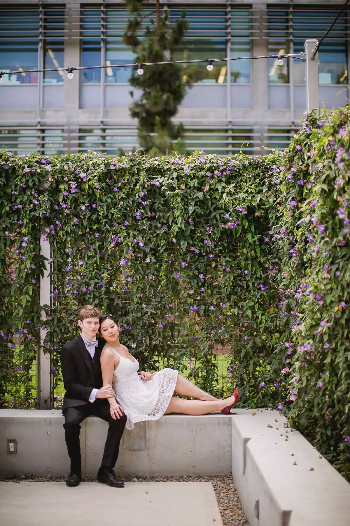 Couple sitting together on campus at UCSD in La Jolla during their San Diego engagement photos
