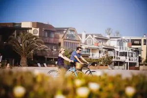 Bike riding in Mission Beach during their engagement shoot