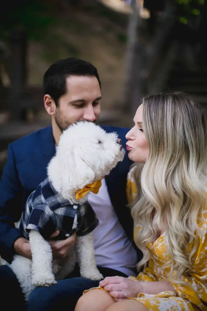 Woman kissing her dog during an engagement session