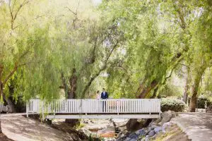 Bride and groom at Old Poway Park on a bridge
