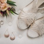 Detail photo of the bride's sparkly wedding shoes and earrings